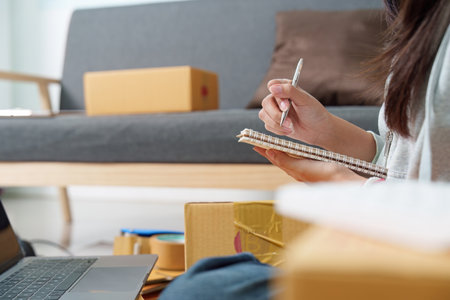 Organizing Shipping Details in a Notebookの写真素材