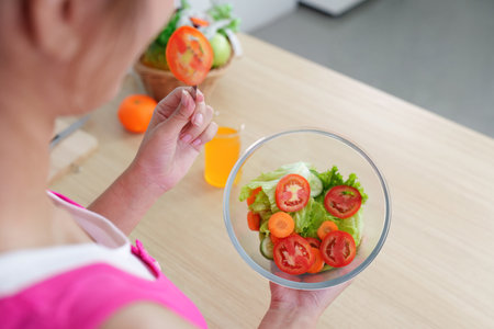 Healthy Lifestyle. Woman preparing fresh salad with colorful vegetables.の写真素材