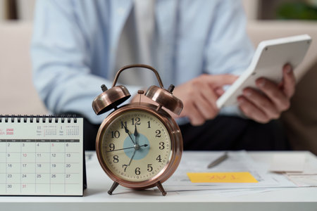 Time Management. Individual planning tasks with calendar and alarm clock on desk.の写真素材