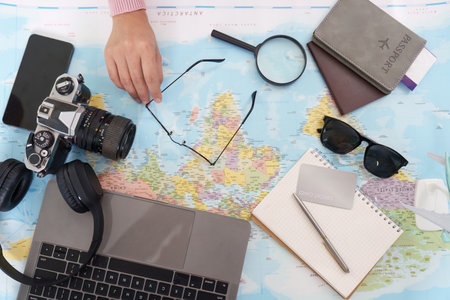 Travel Essentials. Overhead view of travel items on a map.