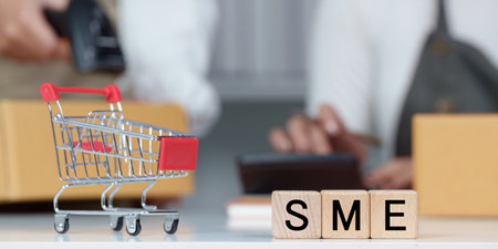 SME Focus. Shopping cart and blocks spelling SME in a business environment.の写真素材