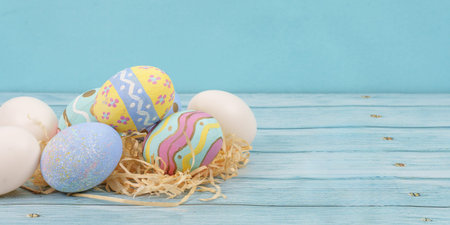 Easter eggs and decorations on wooden backgroundの写真素材