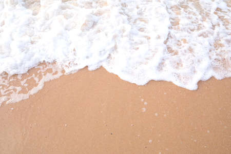Soft wave of the sea on the sandy beach. Summer background.