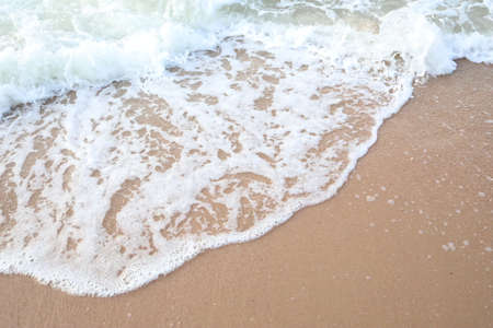 Soft wave of the sea on the sandy beach. Summer background.の写真素材