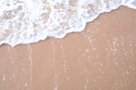 Soft wave of the sea on the sandy beach. Summer background.の写真素材