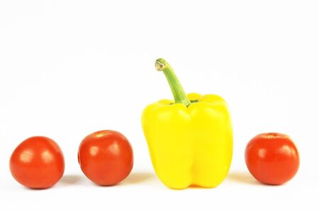 Yellow pepper and tomatoes isolated on whiteの写真素材