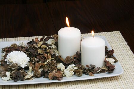 Decorative plate with dried flowers and burning candle - home decoration conceptの写真素材