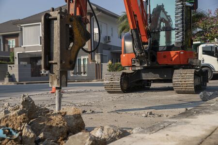 Drilling car machine working on road.