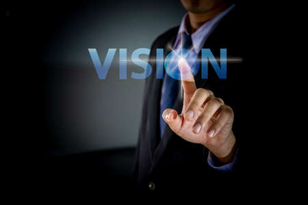 Businessman Hand touching VISION button, modern business technology conceptの写真素材