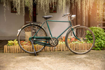 Retro style, Vintage bicycle  parked in front of at home.. Vintage effect.