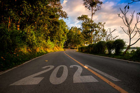 Start of the new year 2021. The number 2021 on a empty Country road in morning a beautiful landscape. New Year conceptsの写真素材