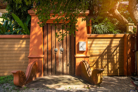 The main Entrance door to a building of the lanna style with the sunlight slanting in at an angle. landscape conceptのeditorial素材