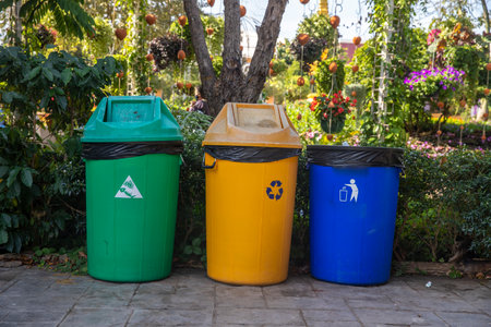 Three color trash cans (garbage bin) in the park beside the walk way. environment conceptの写真素材