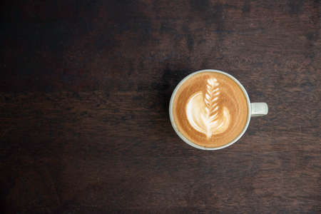 Coffee latte art top view on wood table with copy spaceの写真素材