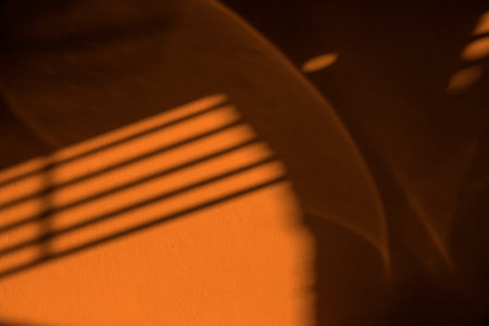 Abstract Background, Shadow and lighting  on the wall., The sun is casting over the orage concrete wall, backgroundの写真素材