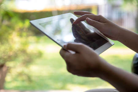 Woman hands holding and pointing on contemporary digital frame on screen.. technology conceptの写真素材