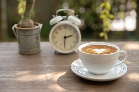 Coffee time concept. cup of coffee latte art on the wood table at home. relaxation conceptの写真素材