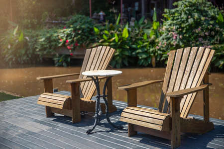 Two wooden easy chairs  on the wood floor in park.. holiday conceptの写真素材
