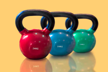 Group of  kettlebells isolated on yellow background. sport conceptの写真素材