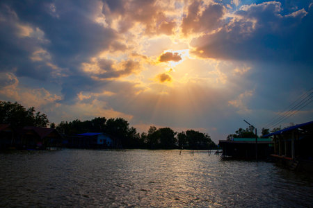 beautiful sunset with silhouette fishman's  villageの写真素材