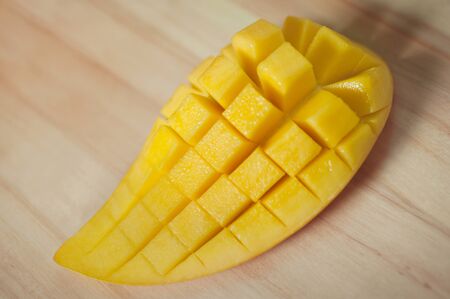 fresh sweet mango slice on wood floorの写真素材