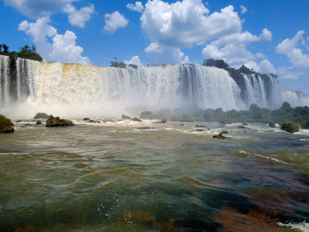 The Iguazy Falls, at the Iguazu National Park, clear water, rocks, blue sky, sunny dayの写真素材