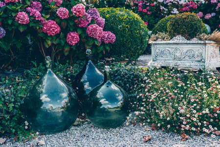 Green bottle lady Jeanne. Decorative object in the gardenの写真素材