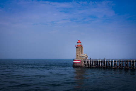 Lighthouse on the pier. Blue sky an blue seaの写真素材