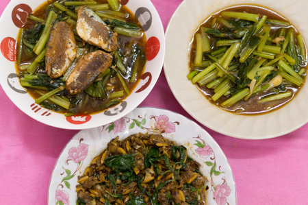 Thai and Chinese food: fried clam, canned fish and Chinese mustard greenの写真素材