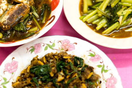 Thai and Chinese food: fried clam, canned fish and Chinese mustard greenの写真素材
