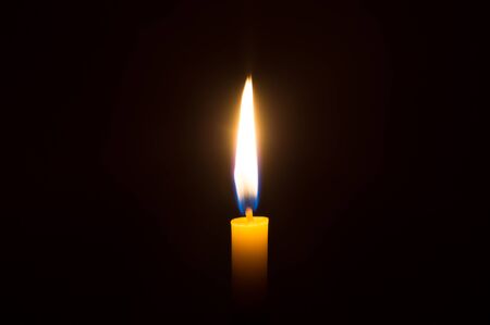 Candle light on dark backgroundの写真素材