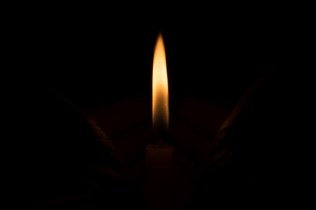 Candle light on dark backgroundの写真素材