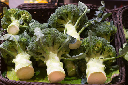 Fresh broccolis in basket on sale in supermarket, healthy broccolis