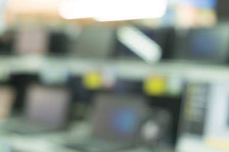 blurred picture background of computer notebooks and large television screens on sale in...