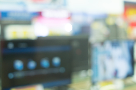 blurred picture background of computer notebooks and large television screens on sale in departmentstore , different models of computer notebooks and large television screens on sale in departmentstore, defocused photo, abstract backgroundの写真素材