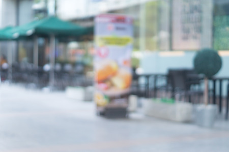 Blurred outside coffee shop with large green umbrellas is close to department store,  blurred patio backgroundの写真素材
