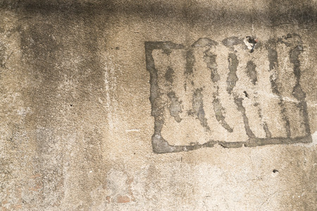 Old concrete background texture with some cracked and stained parts on it, old pale concrete texture with some small holesの写真素材