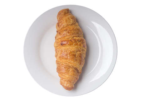 Top view of delicious french croissant on white plate is isolated on white background, crisp pastry bread.の写真素材