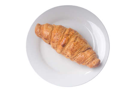 Top view of delicious french croissant on white plate is isolated on white background, crisp pastry bread.の写真素材