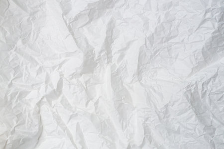 Wrinkled or crumpled white stencil paper or tissue after use in toilet or restroom with large copy space is used for background texture in decorative art work.の写真素材