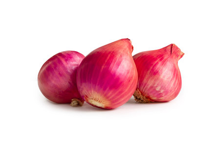 Fresh red onions in stack are isolated on white background with clipping path.の写真素材