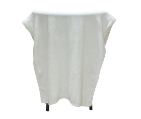 Used white towel laying on chair is isolated on white background with clipping path.の写真素材