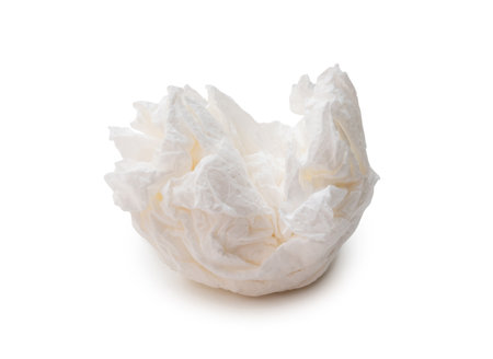 Single screwed or crumpled tissue paper or napkin in strange shape after use in toilet or restroom is isolated on white background with clipping path.の写真素材