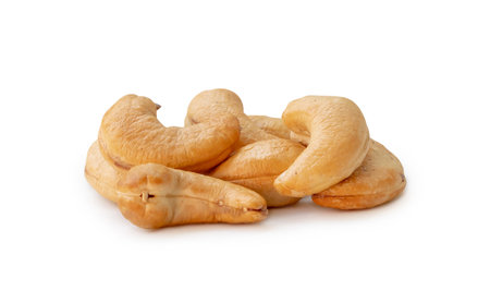 Roasted brown cashew nuts in stack are isolated on white background with clipping path.の写真素材