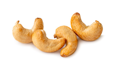 Roasted brown cashew nuts in stack are isolated on white background with clipping path.の写真素材