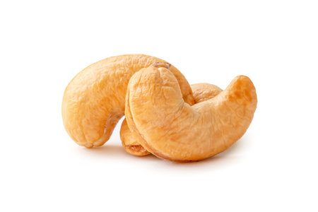 Front view of three Roasted brown cashew nuts in stack are isolated on white background with clipping path. Close up photoの写真素材