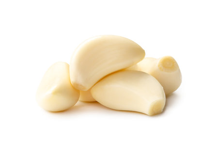 Fresh beautiful whole peeled garlic cloves in stack are isolated on white background with clipping path.の写真素材