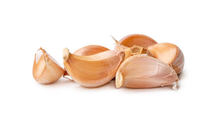 Garlic cloves in stack are isolated on white background with clipping path.の写真素材