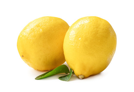 Two whole fresh beautiful yellow lemons with leaves are isolated on white background with clipping path.の写真素材