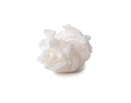Single screwed or crumpled tissue paper or napkin in strange shape after use in toilet or restroom is isolated on white background with clipping path.の写真素材